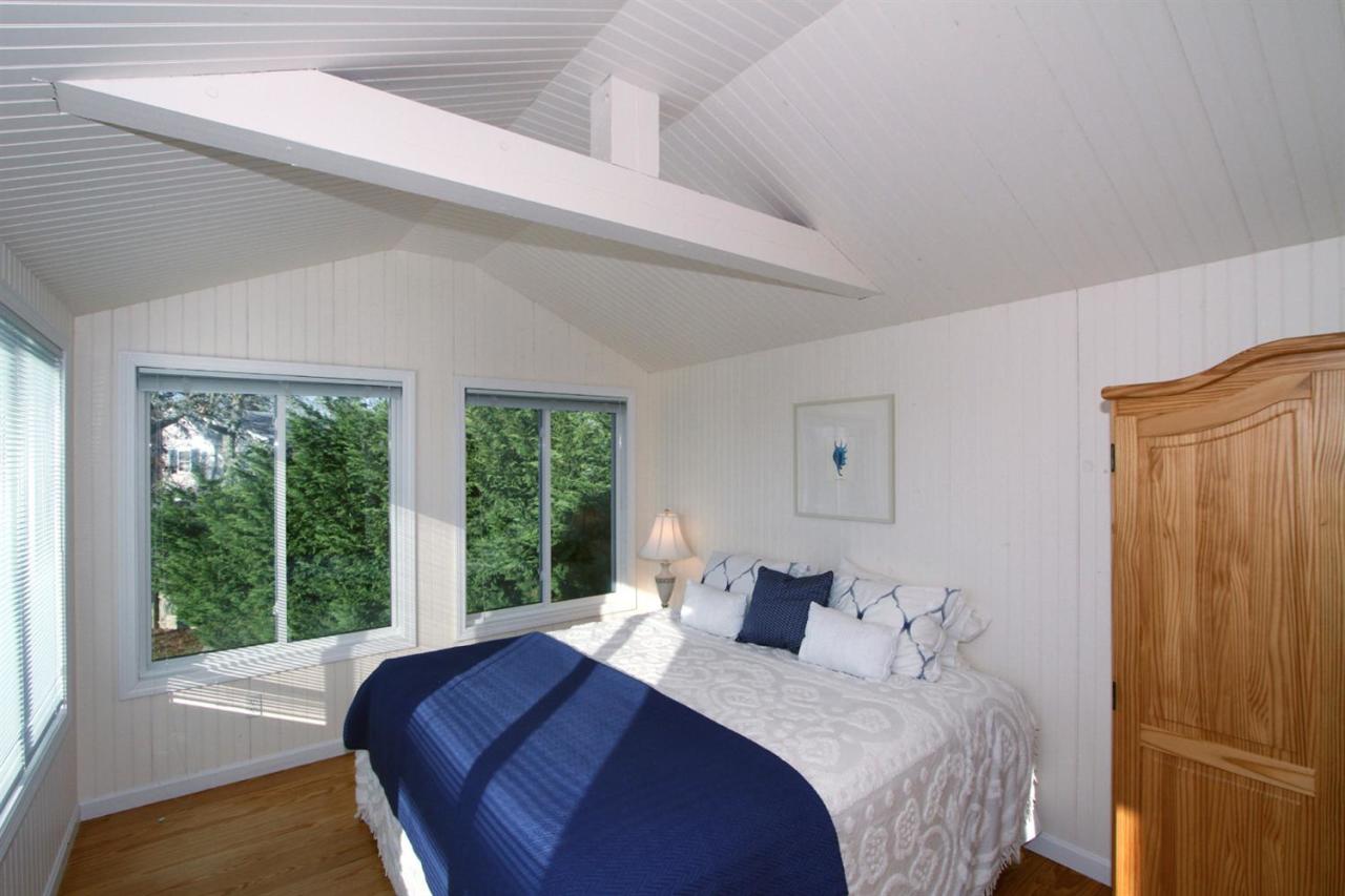 55 Barley Neck Road Orleans, MA 02653 - Photo 24 of 32 a bedroom with a large bed and a large window