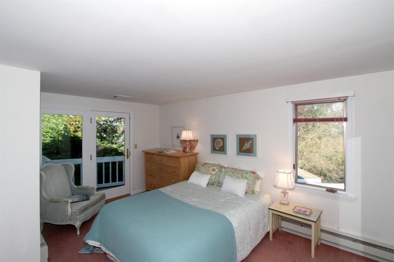 55 Barley Neck Road Orleans, MA 02653 - Photo 27 of 32 a bedroom with a bed and a large window