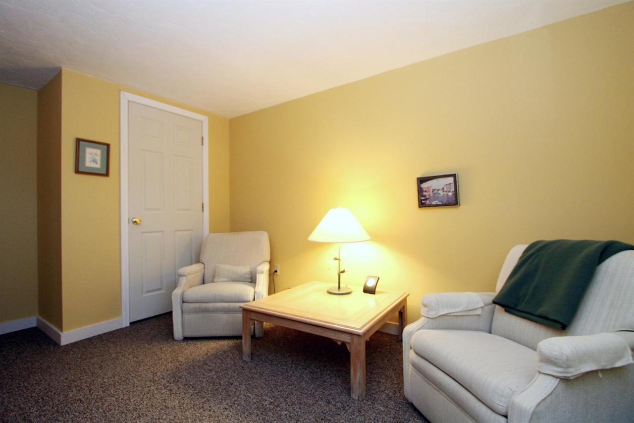 55 Barley Neck Road Orleans, MA 02653 - Photo 28 of 32 a living room with furniture and a lamp