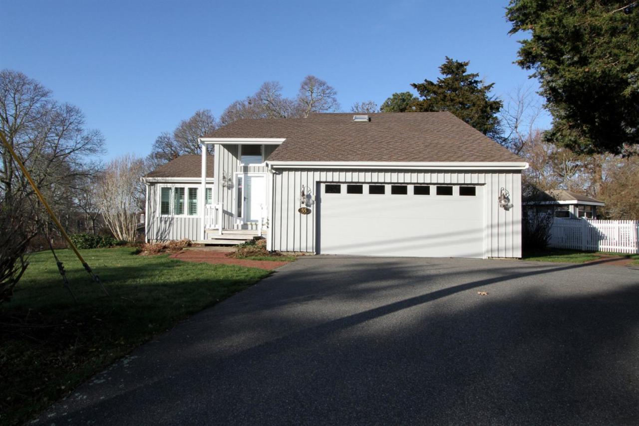 55 Barley Neck Road Orleans, MA 02653 - Photo 4 of 32 a front view of a house with a yard and garage