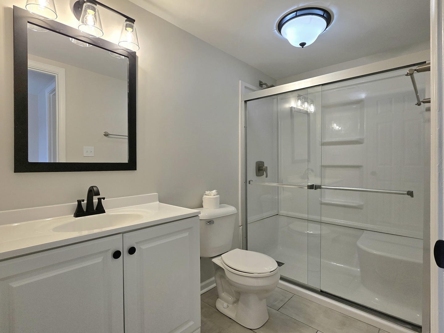 946 West Arlington Lane Crete, IL 60417 - Photo 14 of 27 a bathroom with a toilet a sink a glass door a shower and a mirror