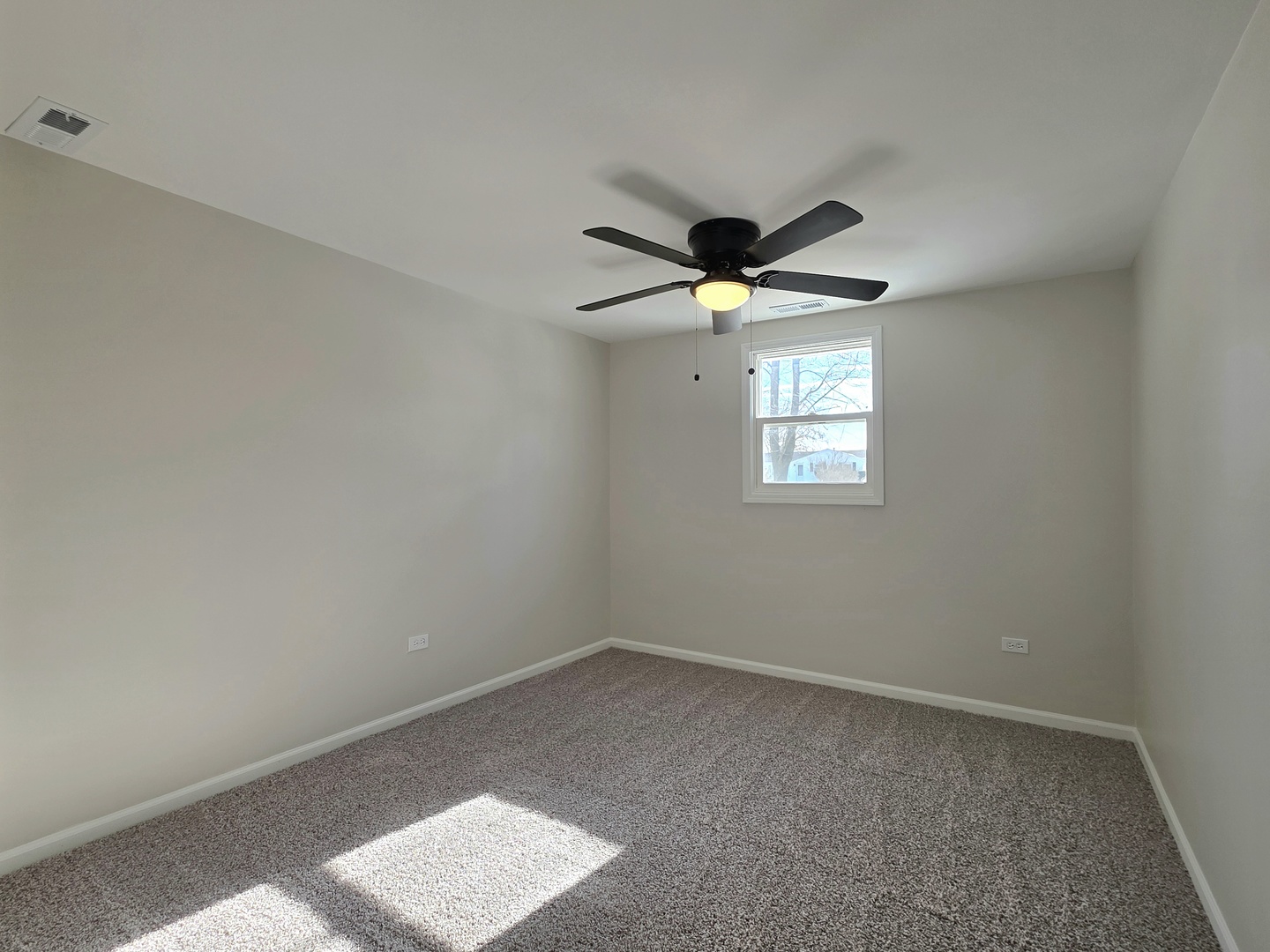 946 West Arlington Lane Crete, IL 60417 - Photo 16 of 27 an empty room with windows and fan