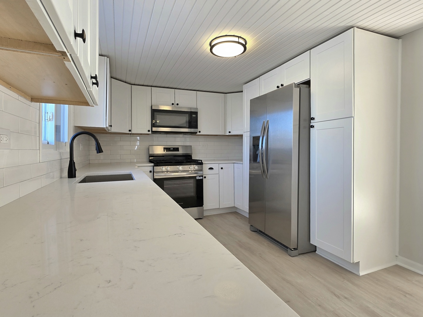 946 West Arlington Lane Crete, IL 60417 - Photo 3 of 27 a kitchen with stainless steel appliances granite countertop a refrigerator a sink a stove and a microwave oven