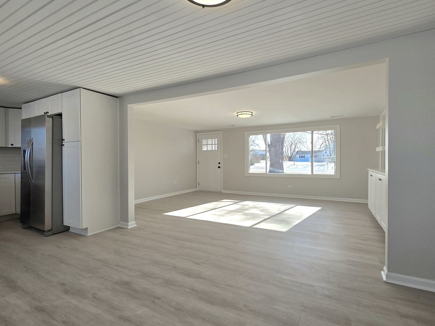 946 West Arlington Lane Crete, IL 60417 - Photo 7 of 27 an empty room with wooden floor and a window
