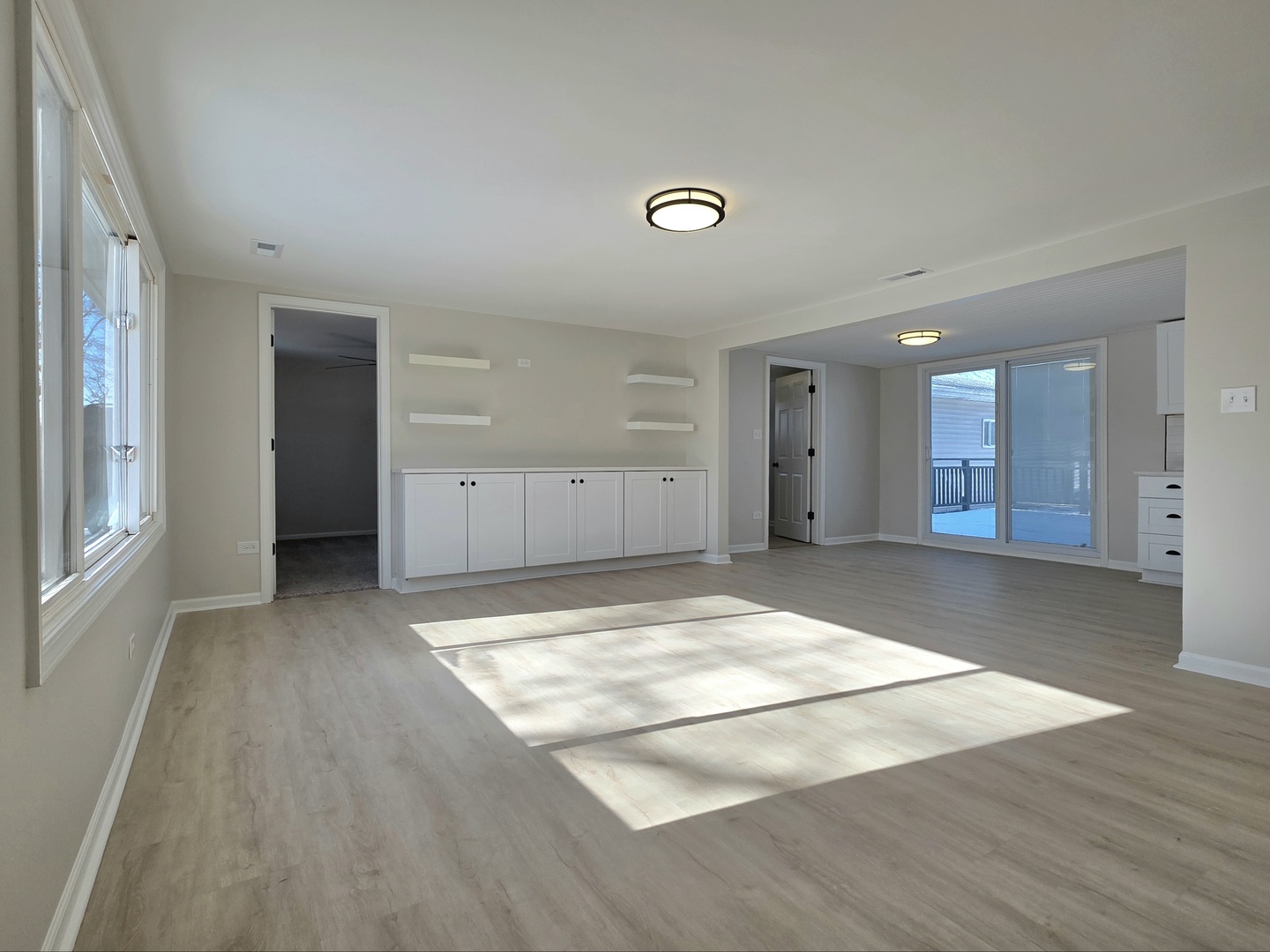 946 West Arlington Lane Crete, IL 60417 - Photo 10 of 27 an empty room with wooden floor and windows