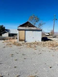 a view of wooden fence and a building in the background
