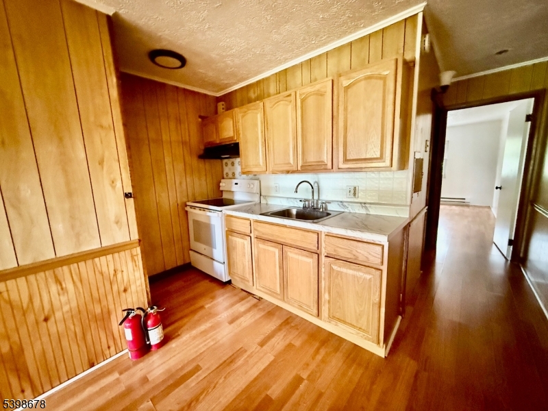 254 Clove Road, Unit H Montague, NJ 07827 - Photo 2 of 10 a kitchen with a sink a refrigerator a window and cabinets
