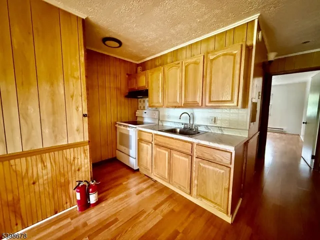 a kitchen with sink cabinets and wooden floor