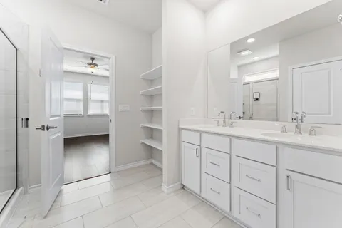 a bathroom with a double vanity sink a and a shower