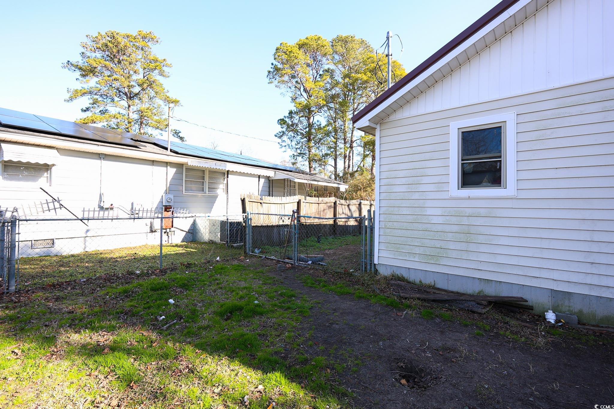 916 Maple Street Mullins, SC 29574 - Photo 11 of 11 View of side of home featuring solar panels