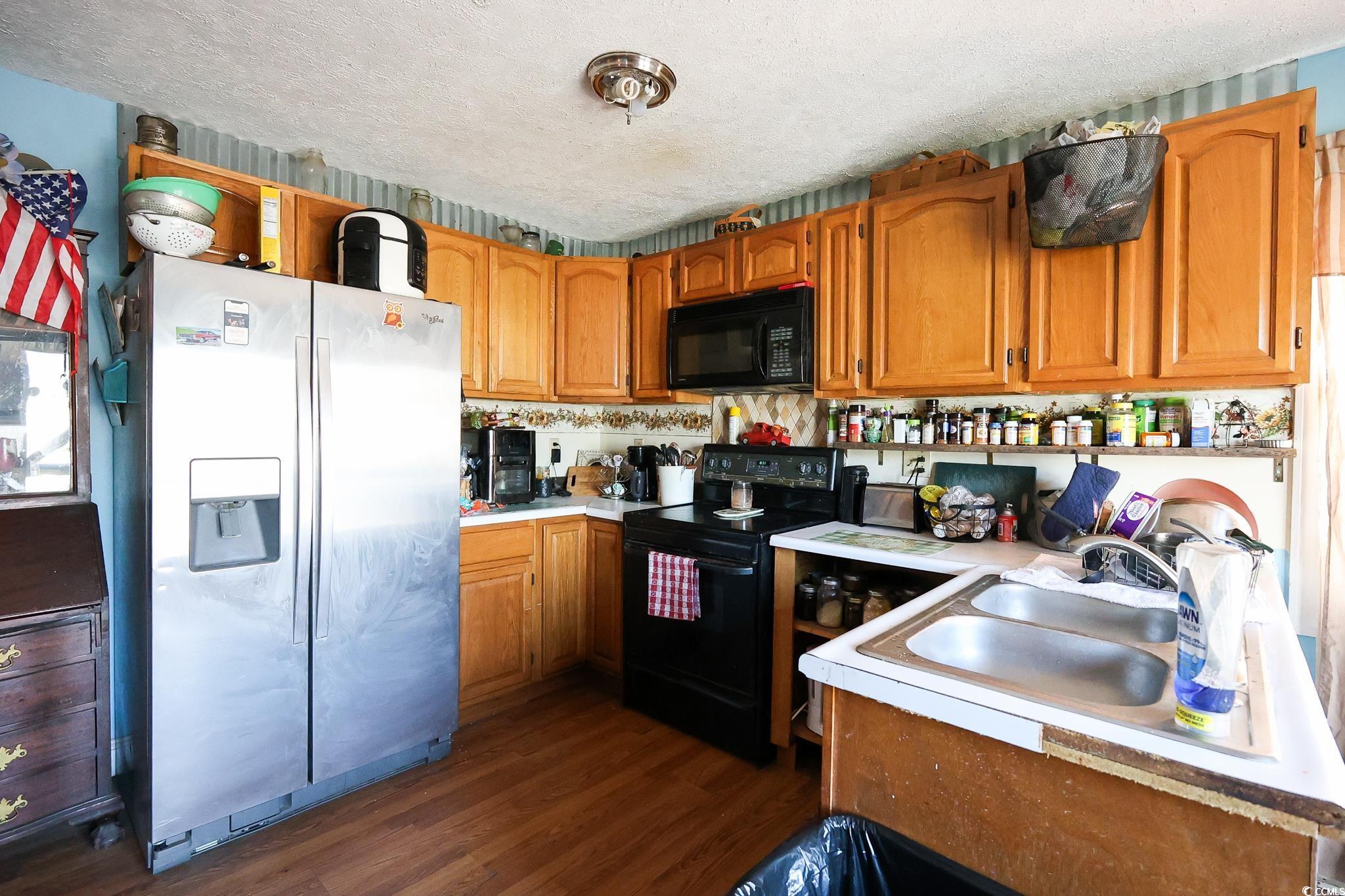 916 Maple Street Mullins, SC 29574 - Photo 3 of 11 Kitchen featuring black appliances, dark wood-type