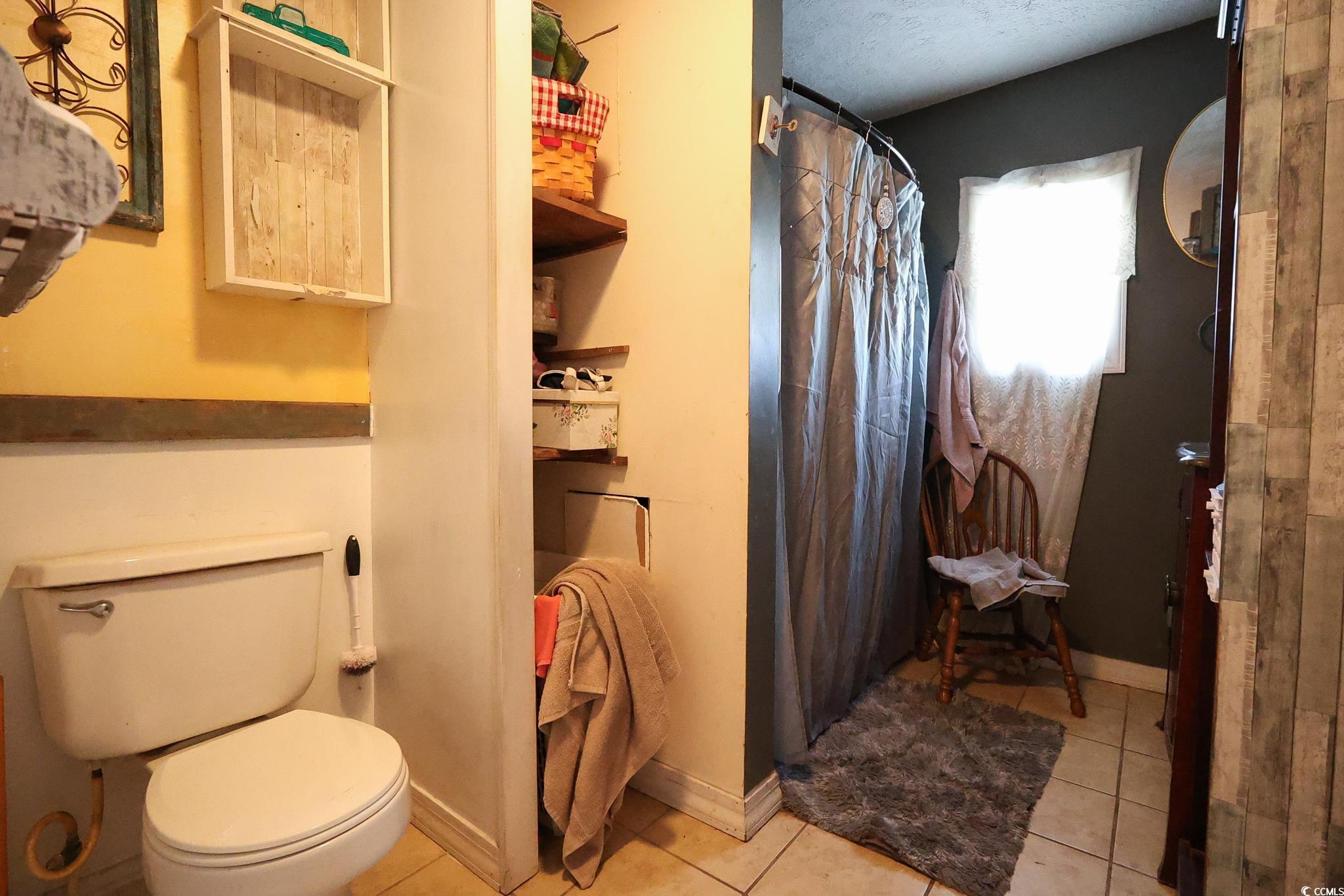 916 Maple Street Mullins, SC 29574 - Photo 5 of 11 Bathroom with toilet, tile patterned flooring, and
