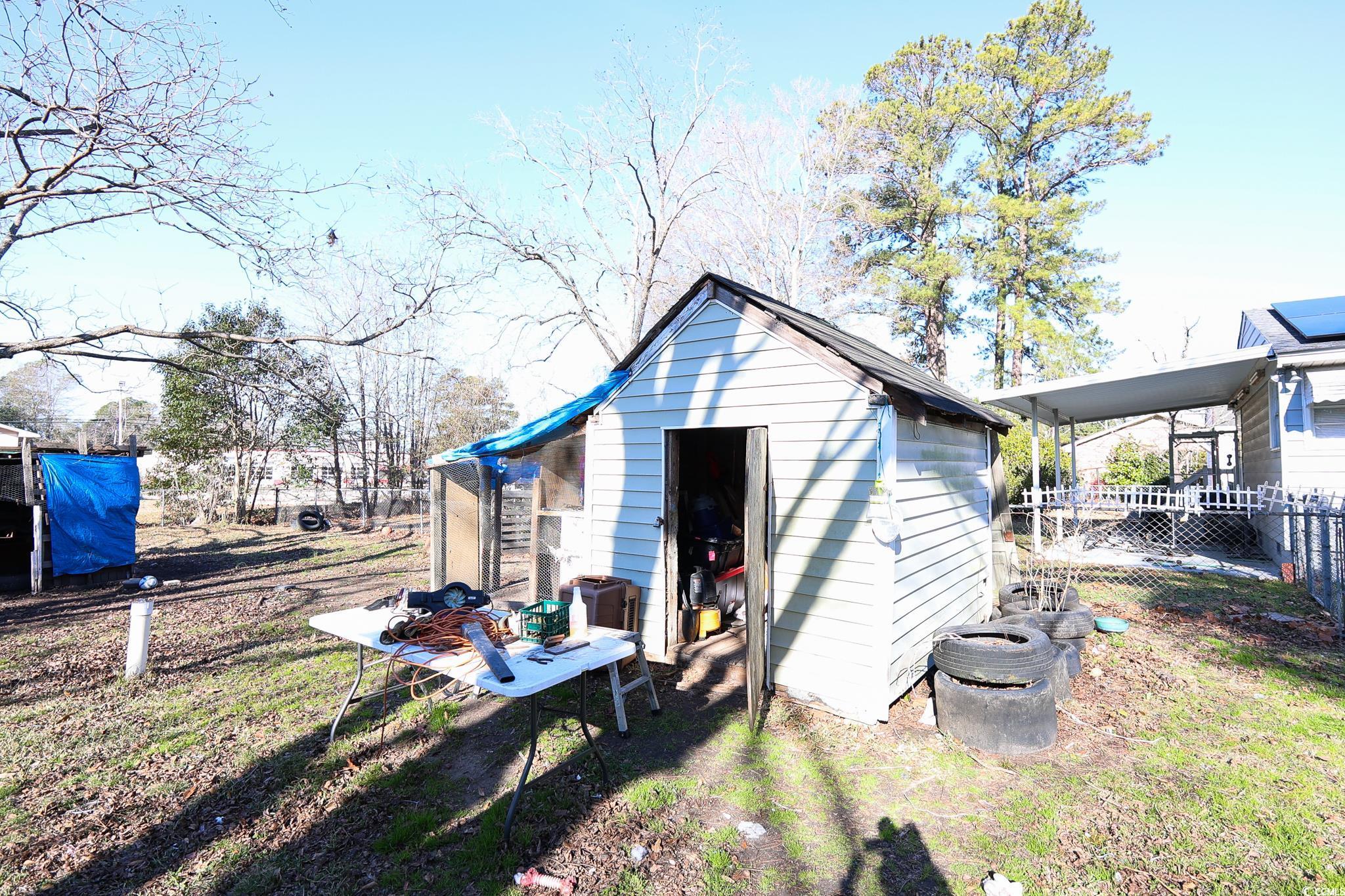 916 Maple Street Mullins, SC 29574 - Photo 9 of 11 Back of house featuring a storage shed