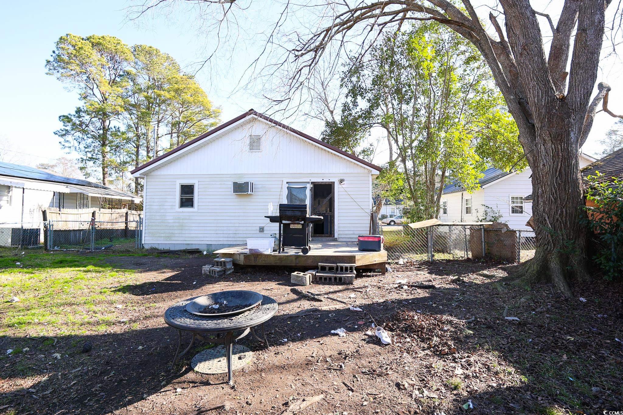 916 Maple Street Mullins, SC 29574 - Photo 10 of 11 Rear view of property with an outdoor fire pit, a