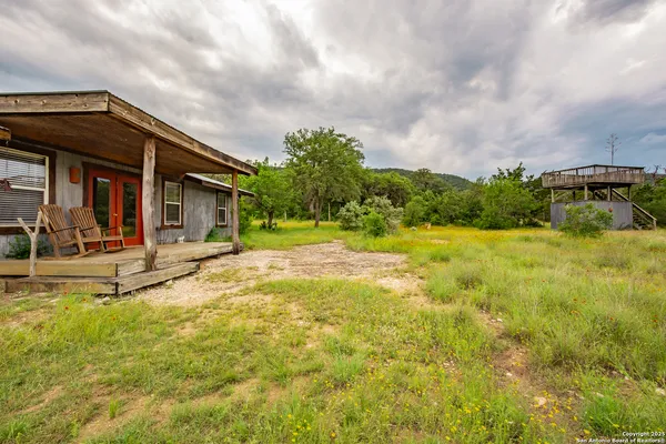 a view of a house with pool and sitting area