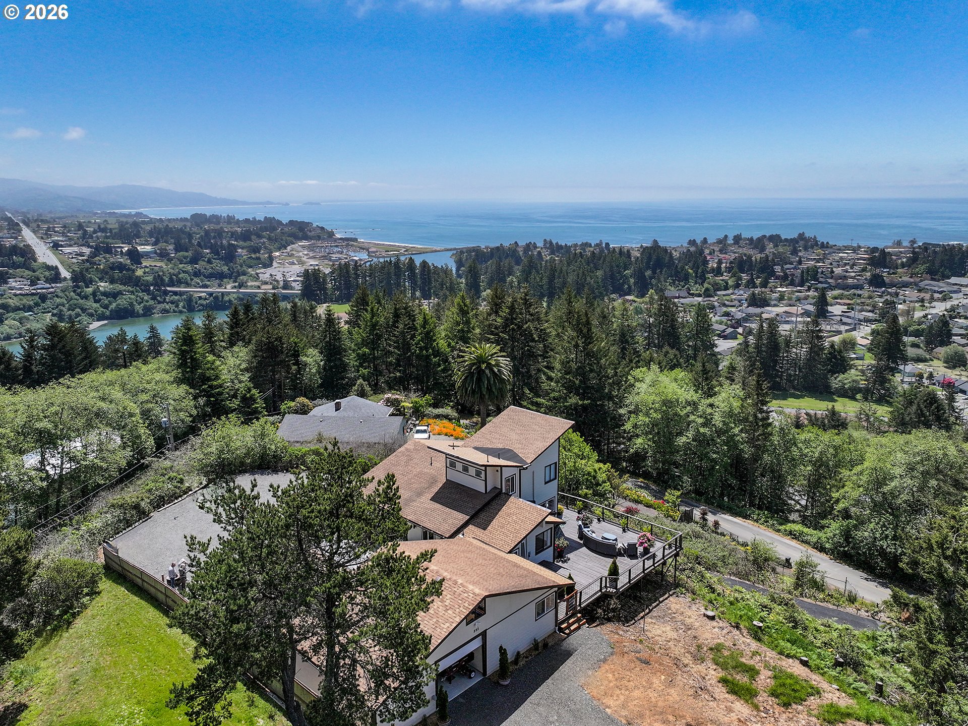 895 Marina Heights Road Brookings, OR 97415 - Photo 1 of 48 an aerial view of a house with a yard and lake view