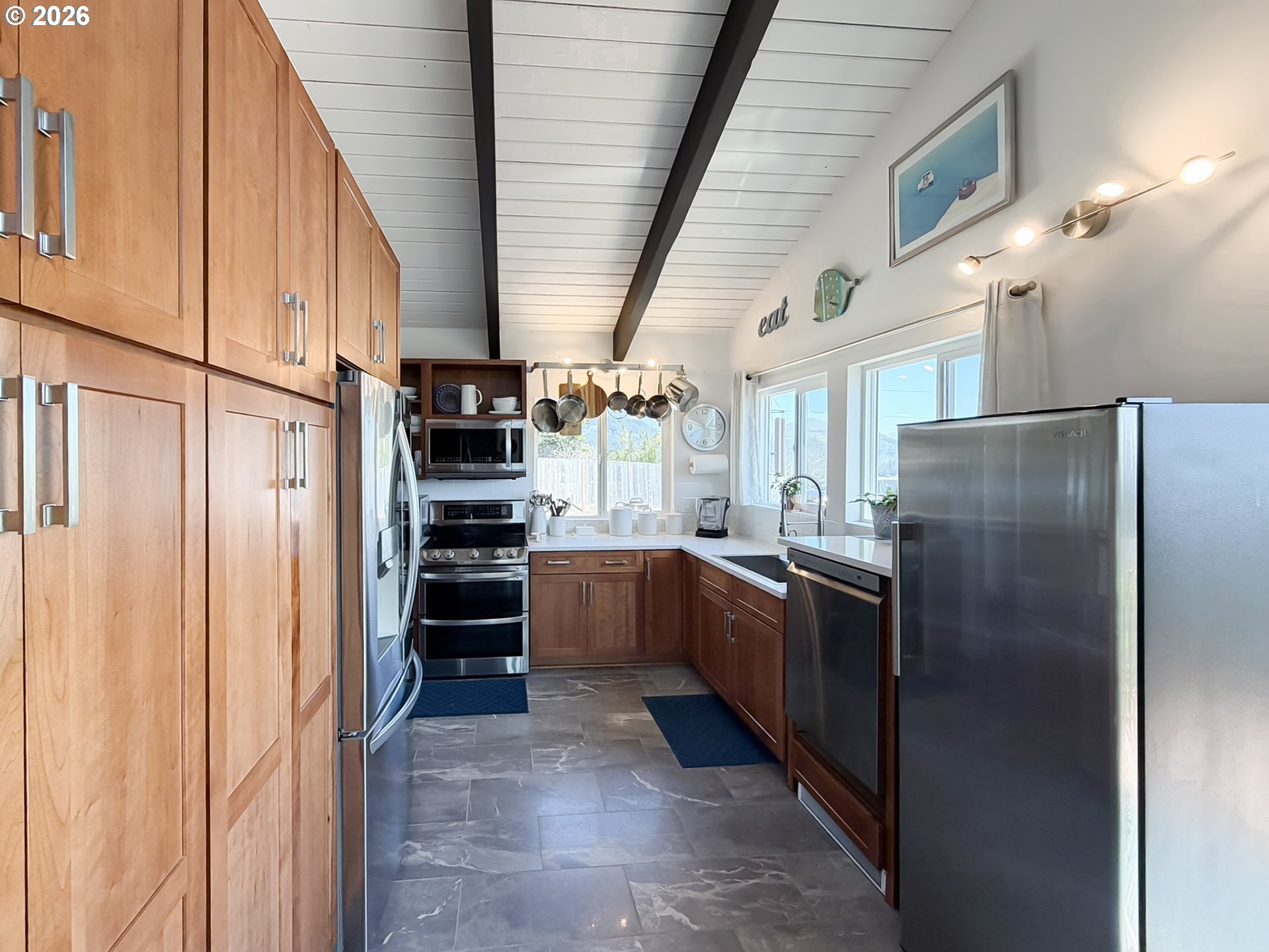 895 Marina Heights Road Brookings, OR 97415 - Photo 15 of 48 a kitchen with stainless steel appliances granite countertop a refrigerator and a stove