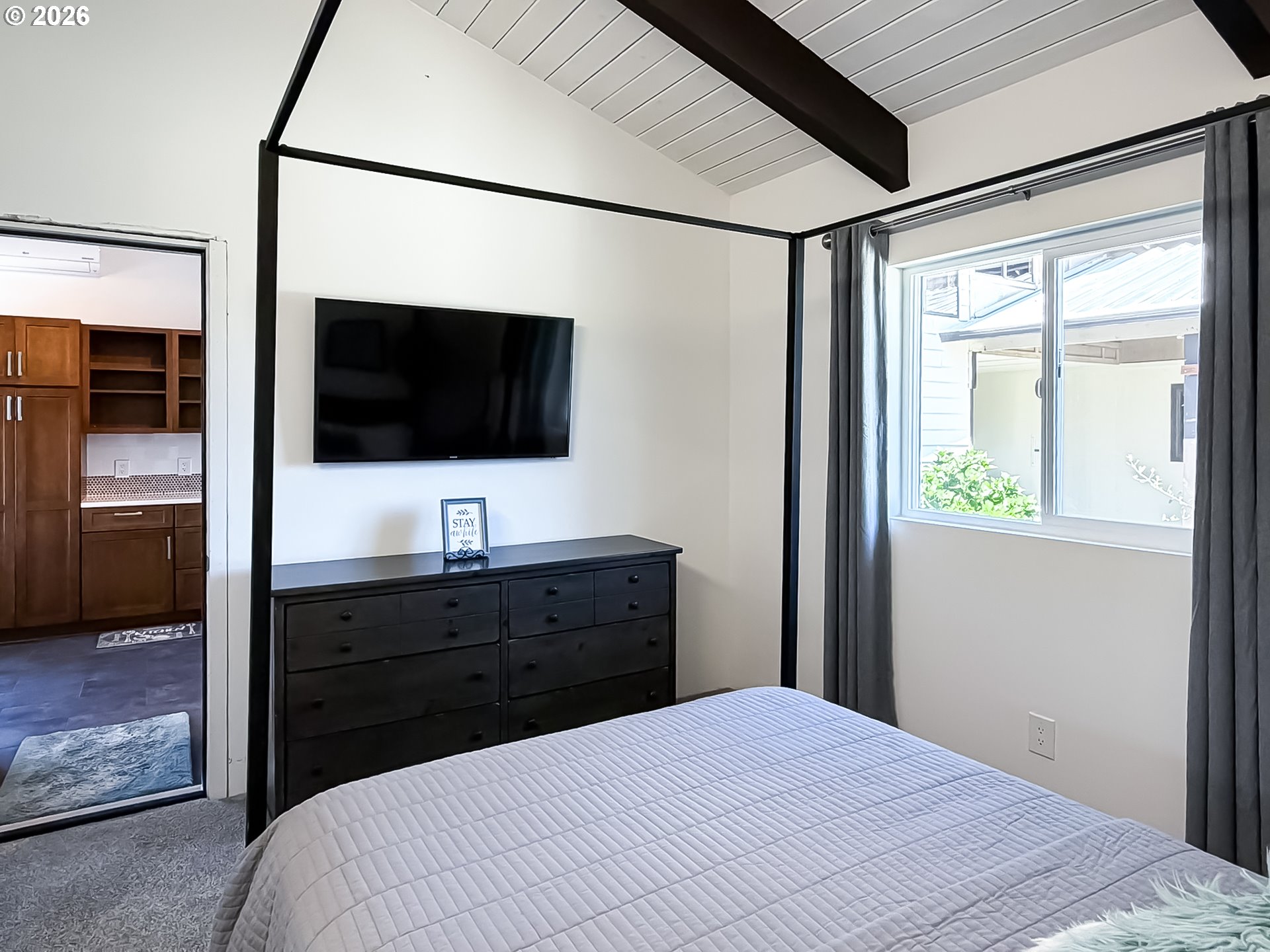 895 Marina Heights Road Brookings, OR 97415 - Photo 19 of 48 a bedroom with a bed and a flat screen tv