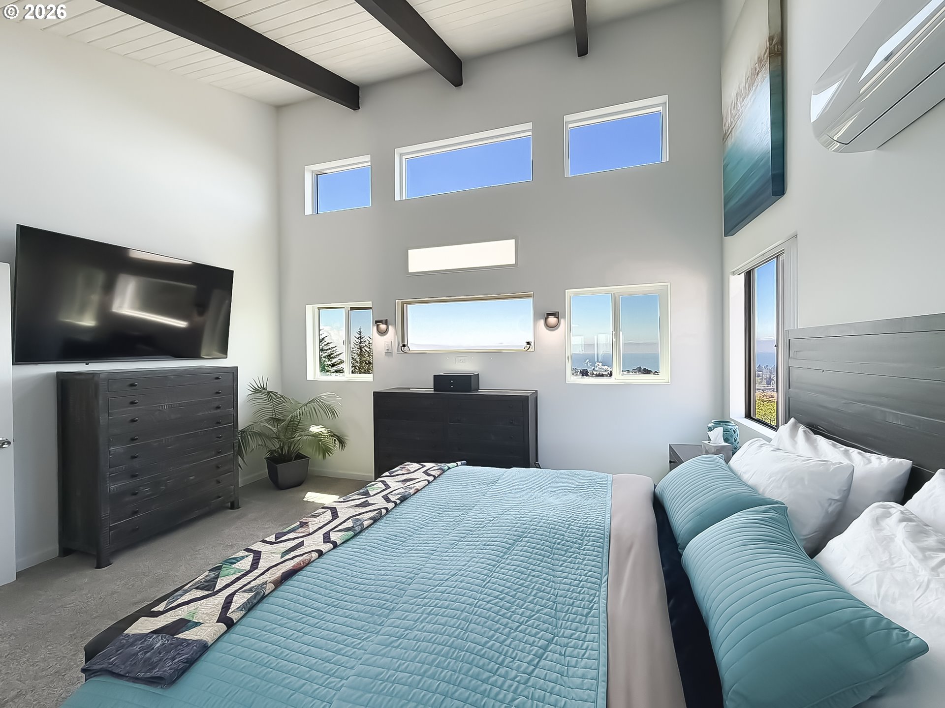 895 Marina Heights Road Brookings, OR 97415 - Photo 23 of 48 a bedroom with a bed and flat screen tv