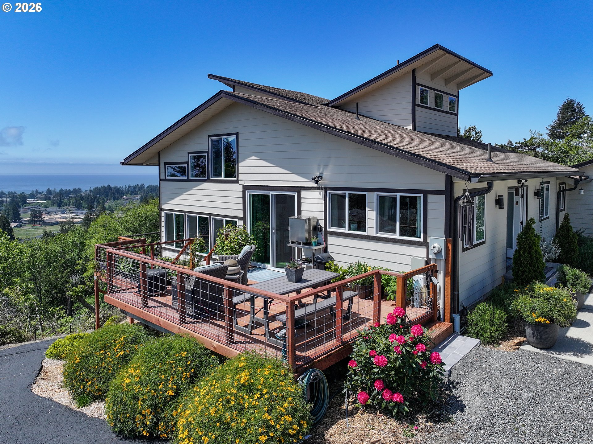 895 Marina Heights Road Brookings, OR 97415 - Photo 3 of 48 a view of a house with sitting area and garden