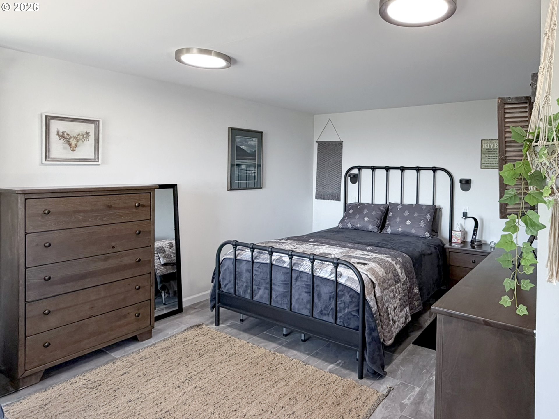 895 Marina Heights Road Brookings, OR 97415 - Photo 39 of 48 a bedroom with a bed and a painting on the wall