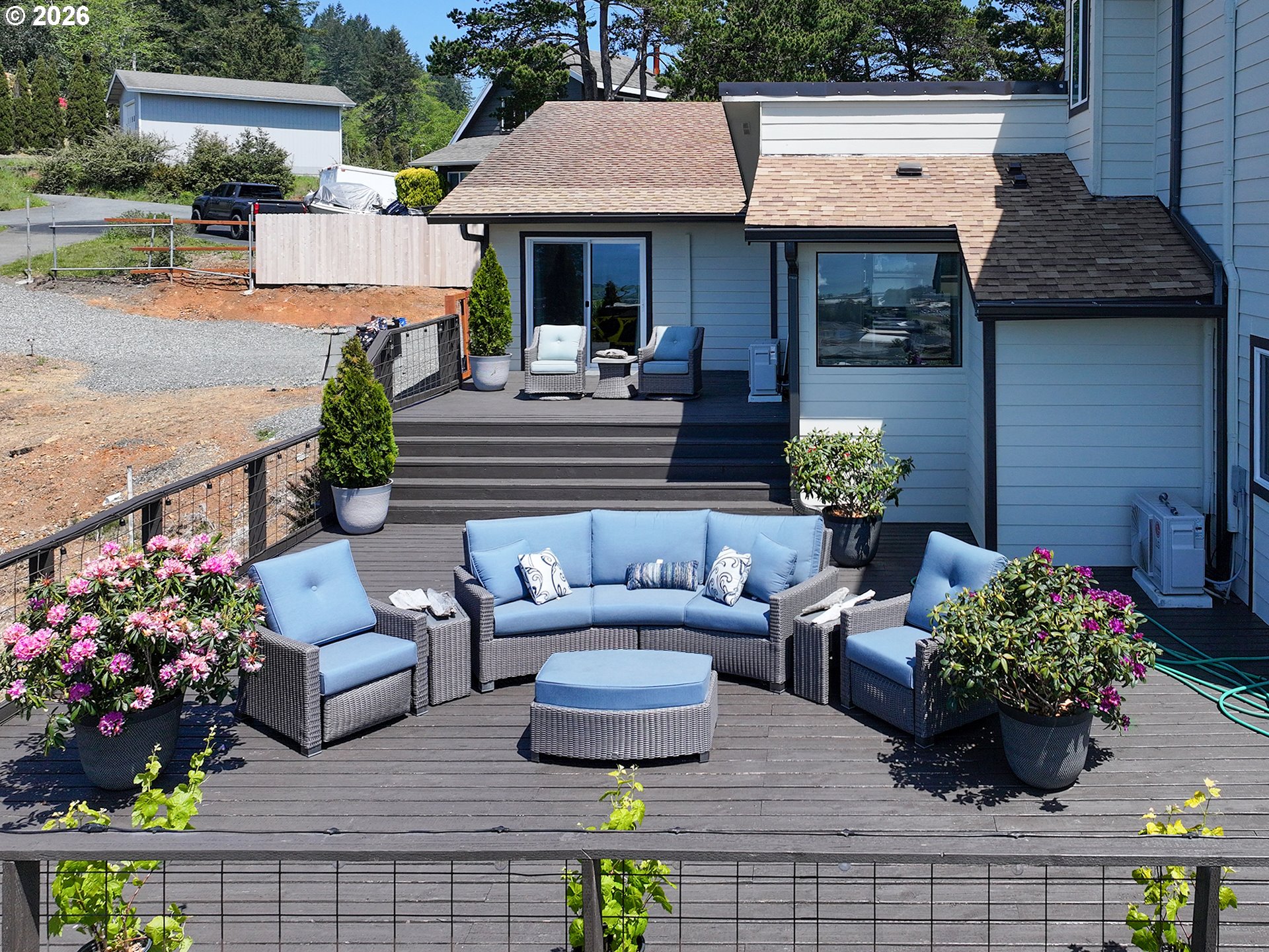 895 Marina Heights Road Brookings, OR 97415 - Photo 41 of 48 a view of a patio with couches table and chairs and potted plants