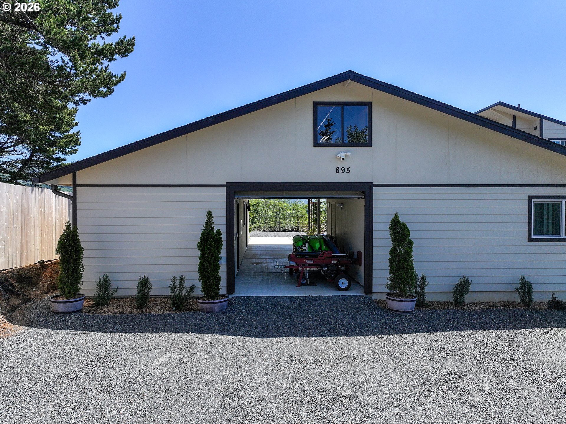 895 Marina Heights Road Brookings, OR 97415 - Photo 44 of 48 a front view of a house with garden
