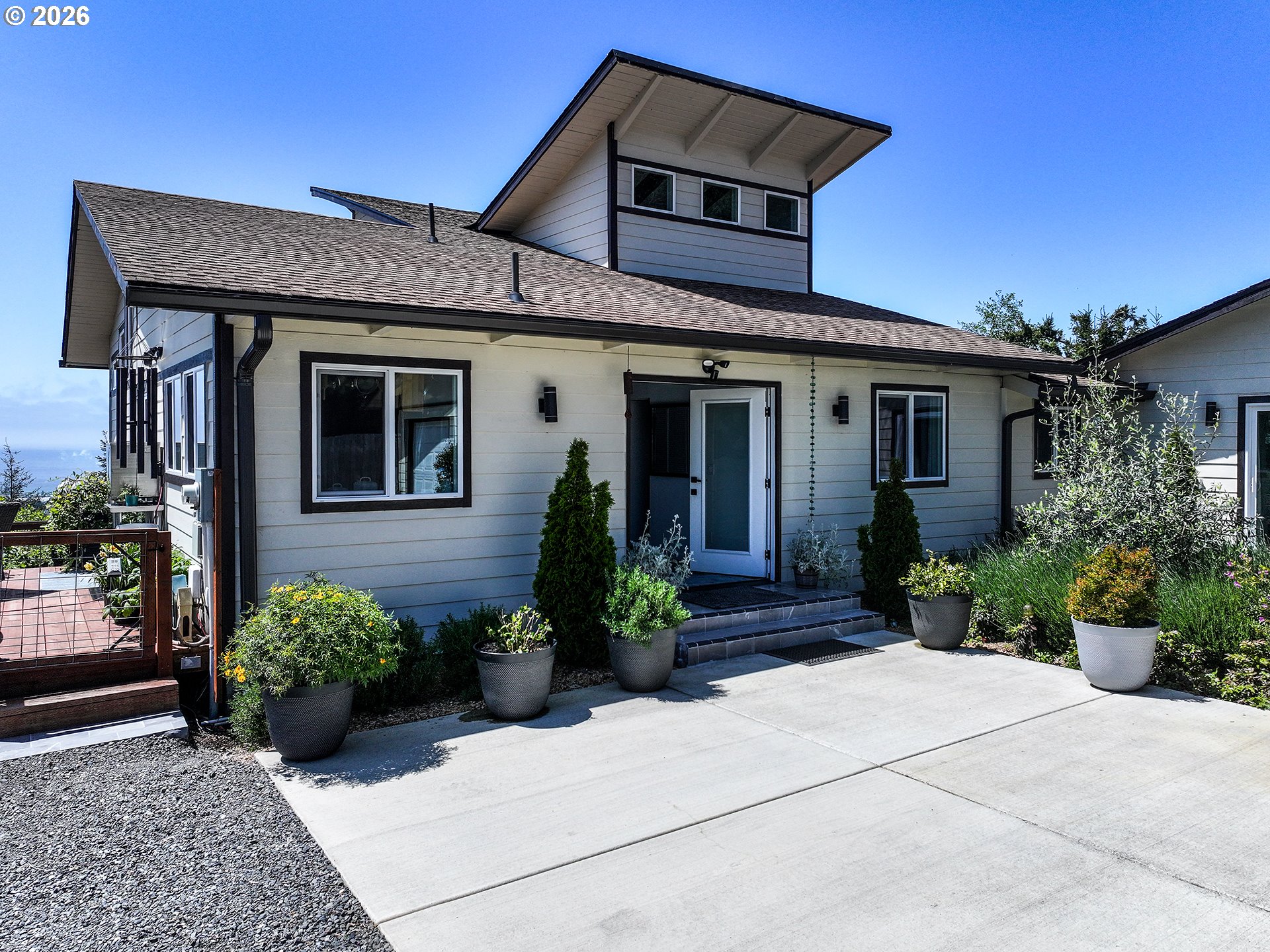 895 Marina Heights Road Brookings, OR 97415 - Photo 6 of 48 a front view of a house with potted plants