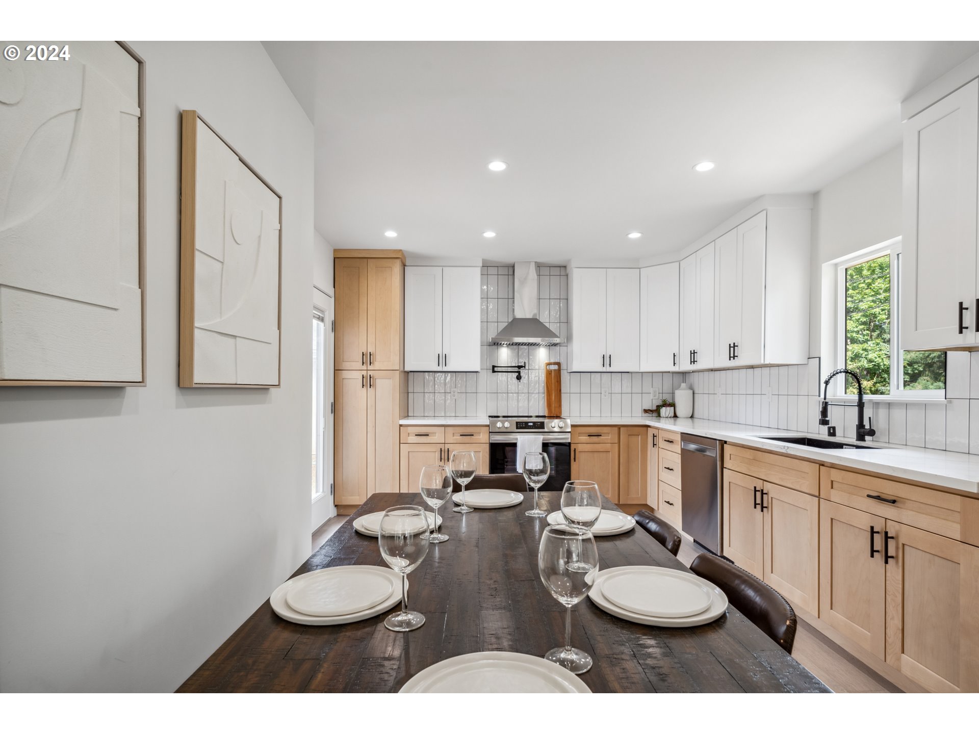 2904 R Street Vancouver, WA 98663 - Photo 11 of 46 a kitchen with a sink dishwasher a stove and white cabinets with wooden floor