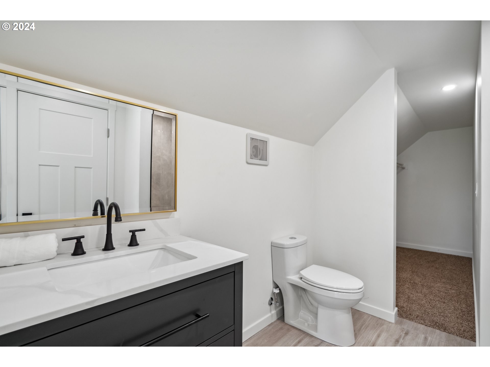 2904 R Street Vancouver, WA 98663 - Photo 25 of 46 a bathroom with a sink a toilet a mirror and shower
