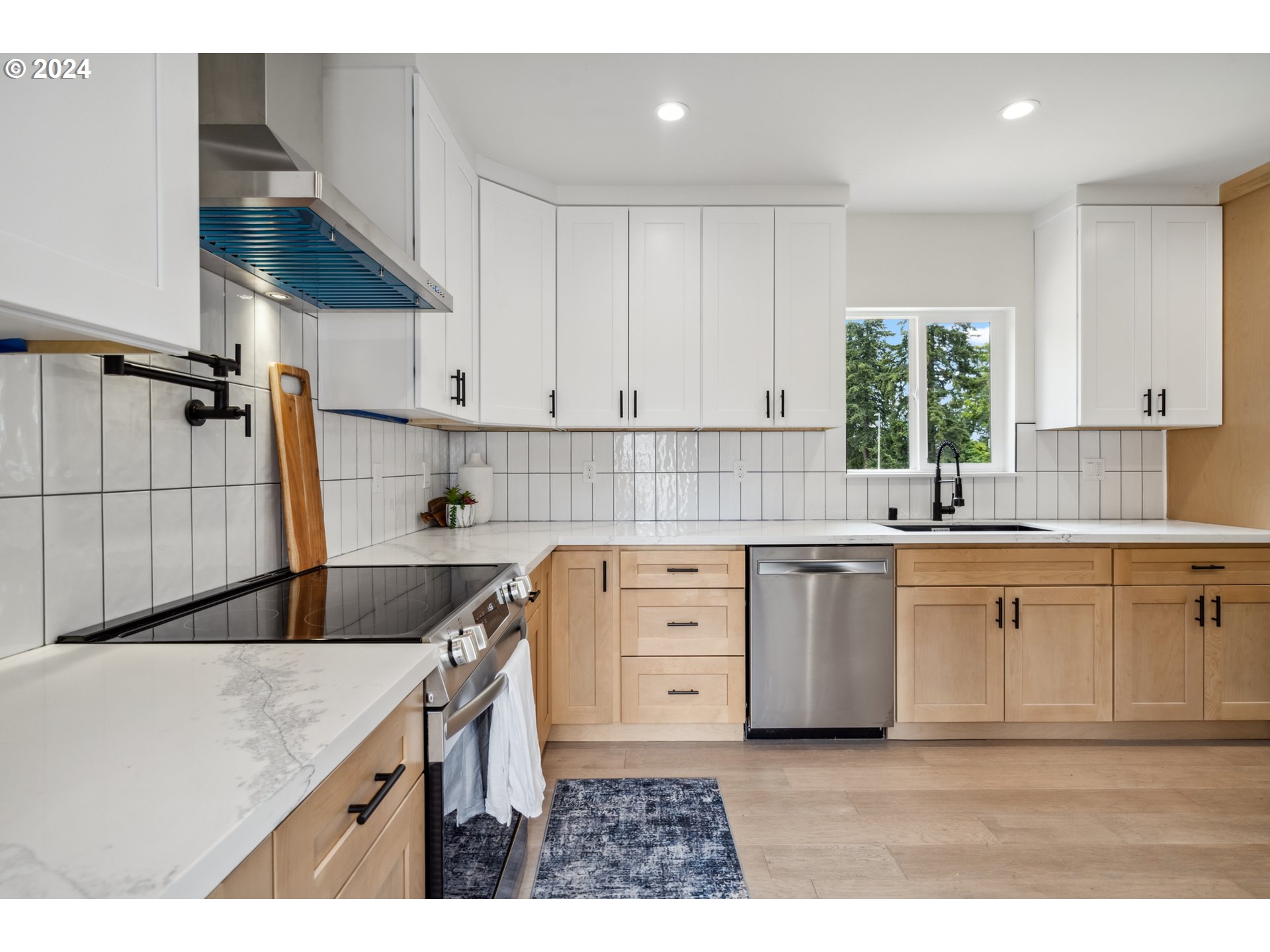 2904 R Street Vancouver, WA 98663 - Photo 9 of 46 a kitchen with a sink stove and cabinets