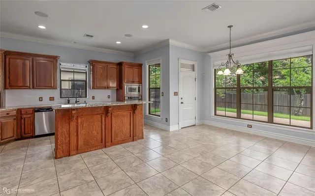 a kitchen with stainless steel appliances granite countertop a stove a sink dishwasher and a refrigerator