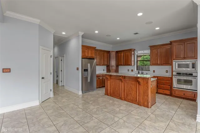 a large kitchen with stainless steel appliances lots of counter top space