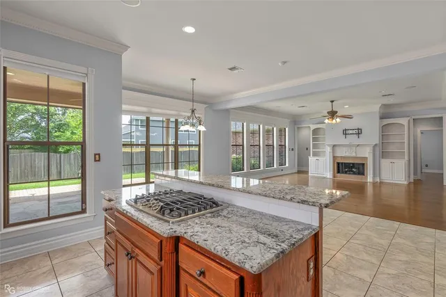 a kitchen with sink stove and refrigerator