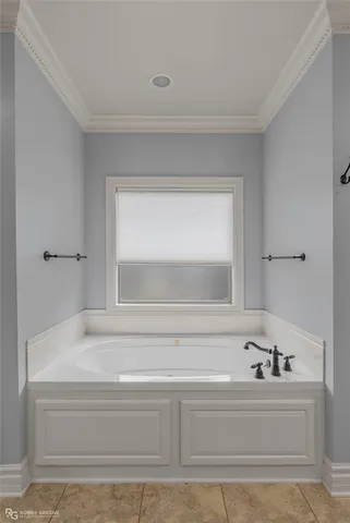 a bathroom with bathtub and mirror