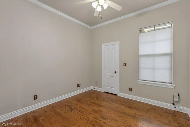 an empty room with closet and windows