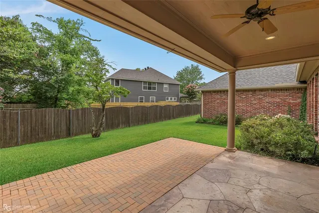 a view of a backyard with wooden fence