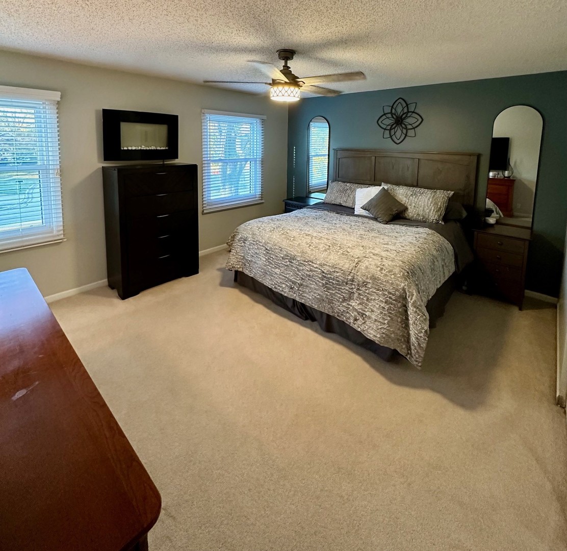 999 Confederation Drive Bartlett, IL 60103 - Photo 11 of 26 a bedroom with a bed and a dresser