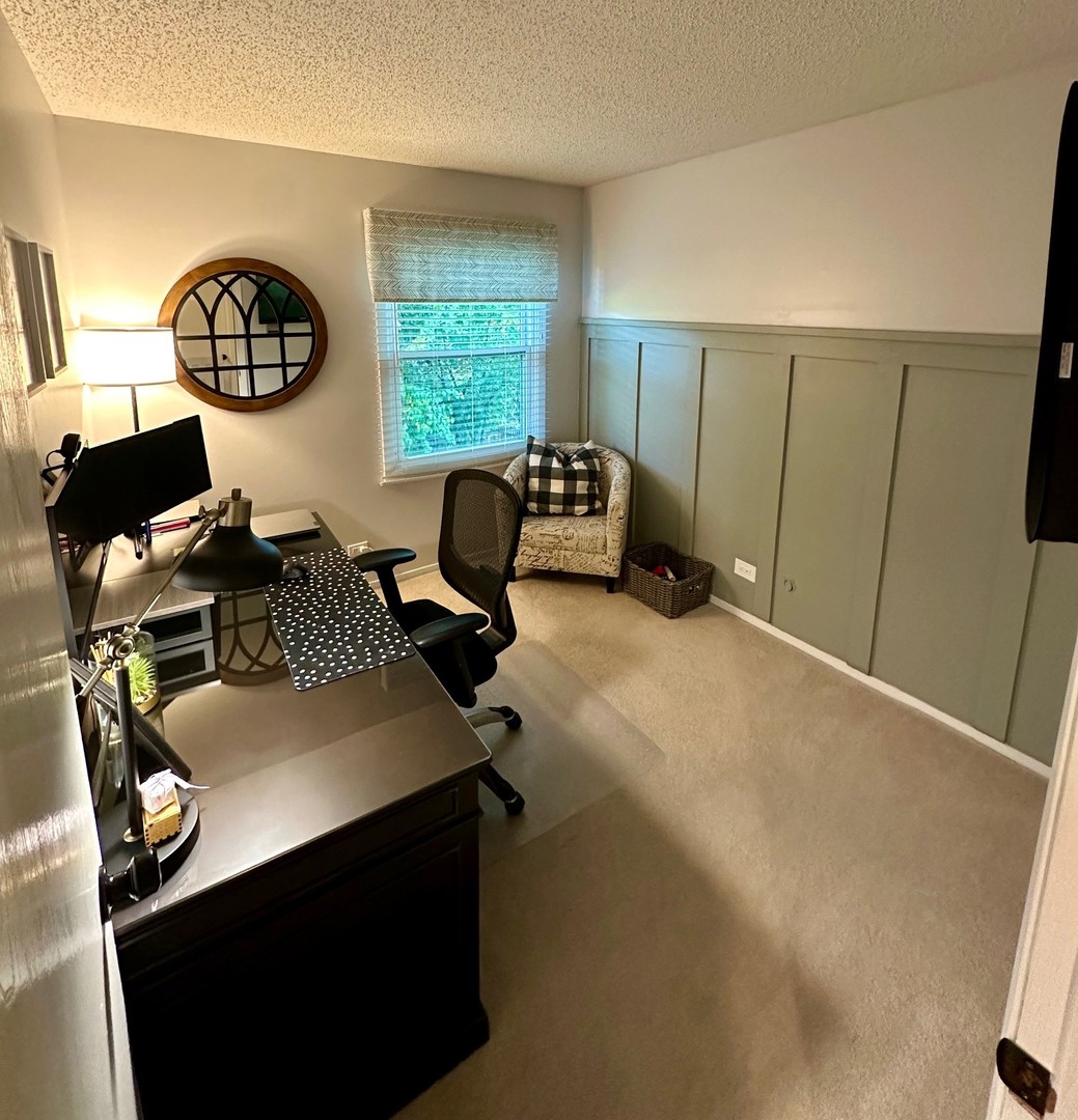 999 Confederation Drive Bartlett, IL 60103 - Photo 15 of 26 a view of workspace with wooden floor windows gym equipment