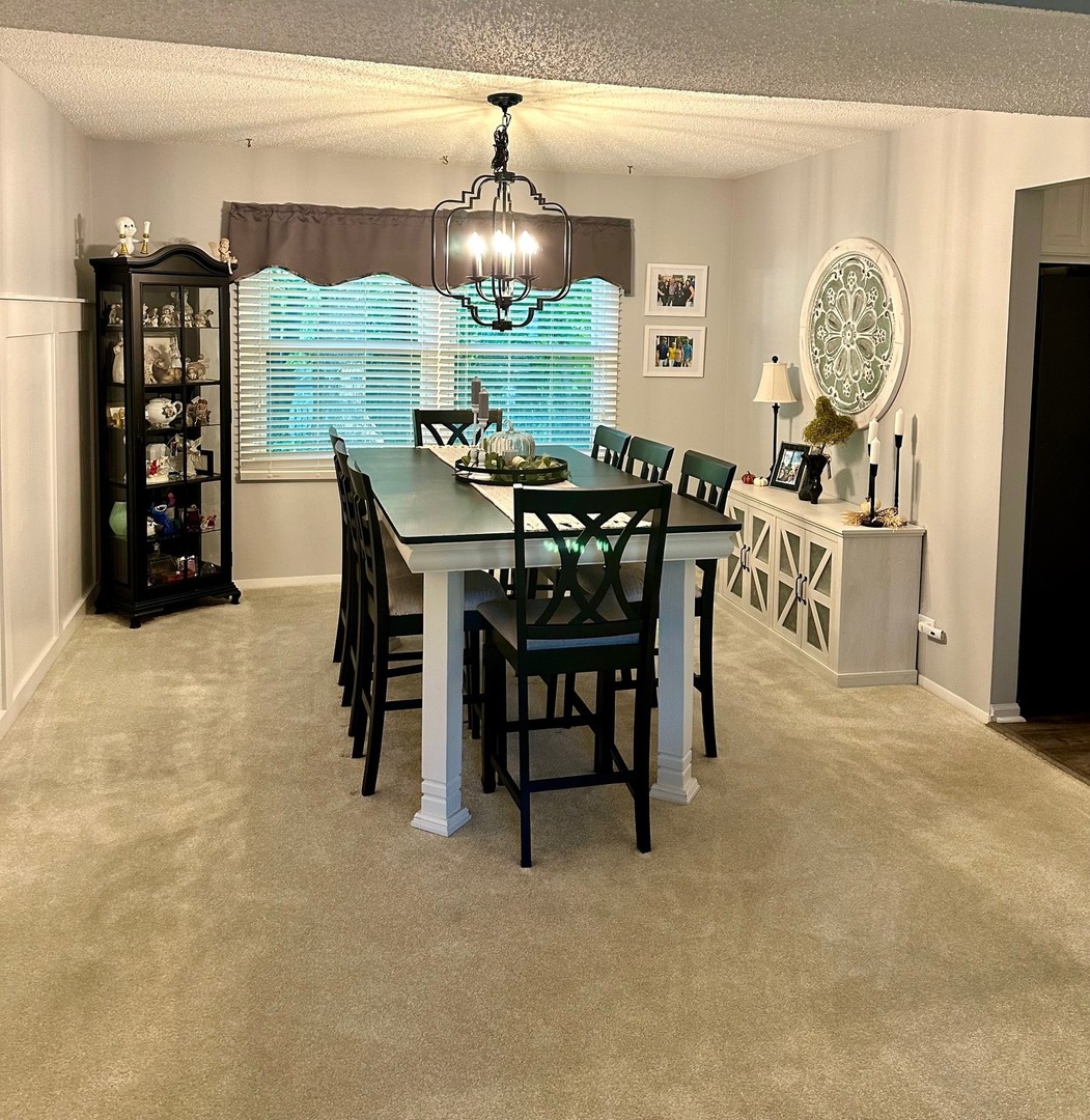 999 Confederation Drive Bartlett, IL 60103 - Photo 6 of 26 a view of a dining room with furniture and chandelier