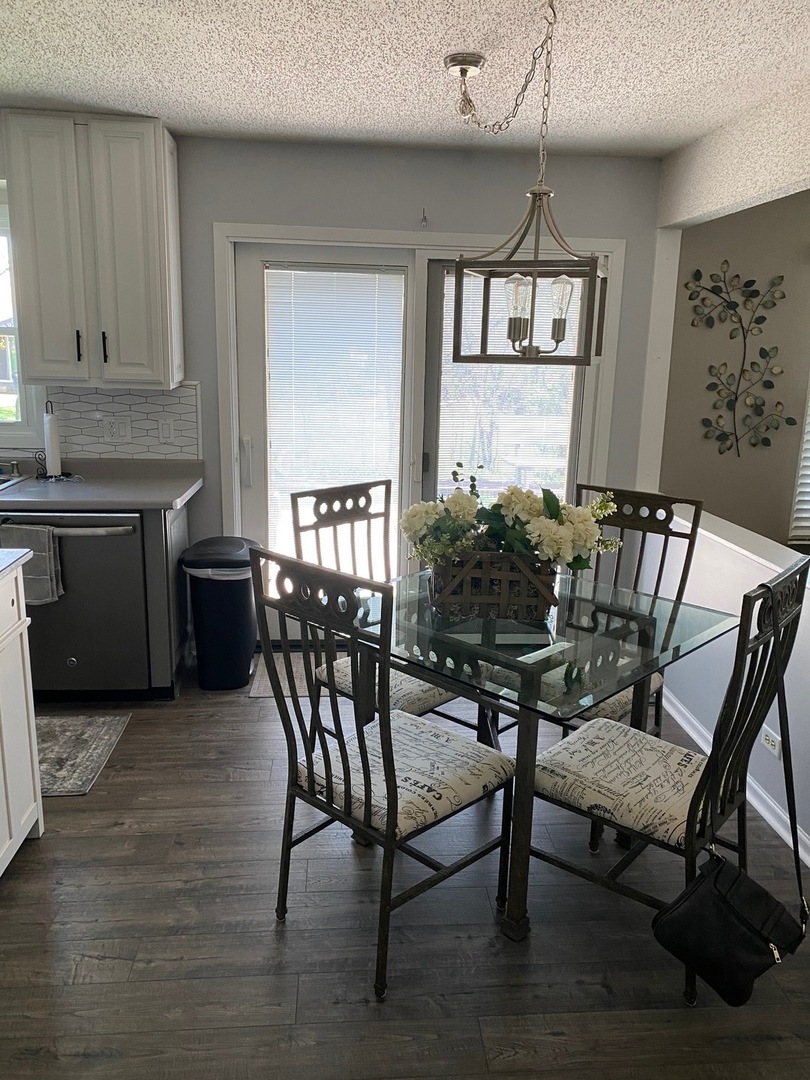 999 Confederation Drive Bartlett, IL 60103 - Photo 8 of 26 a view of a dining room with furniture window and wooden floor