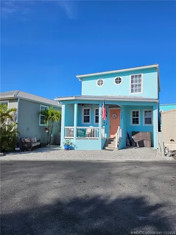 a front view of a building with small garden