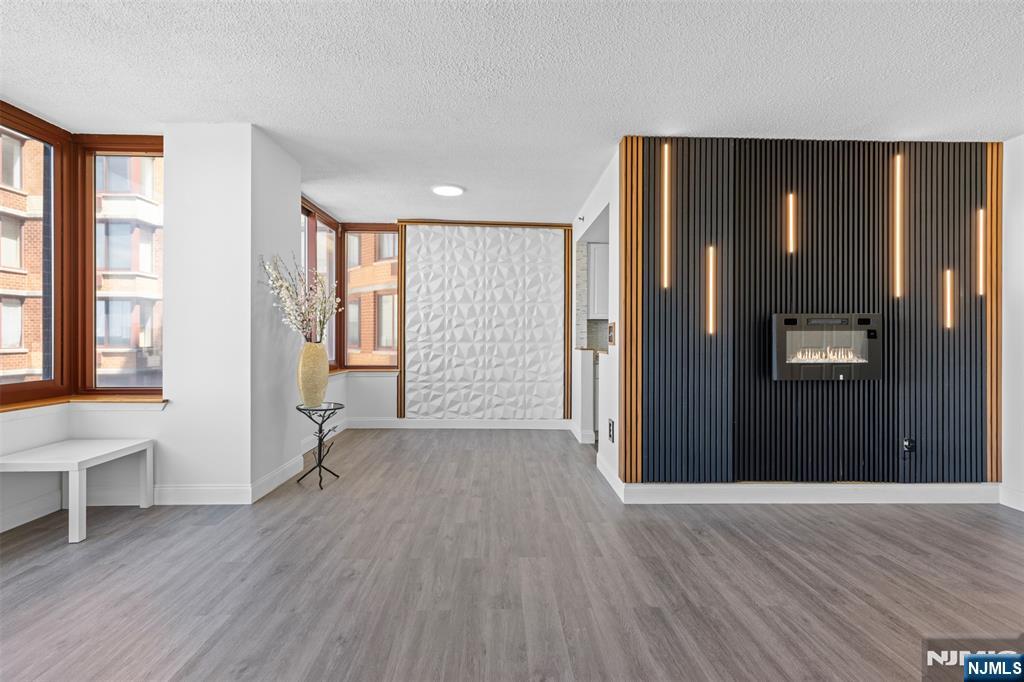 100 Old Palisade Road, Unit 3215 Fort Lee, NJ 07024 - Photo 4 of 43 an empty room with wooden floor and windows