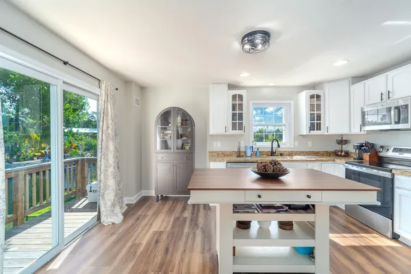 a bathroom with a toilet sink vanity and mirror