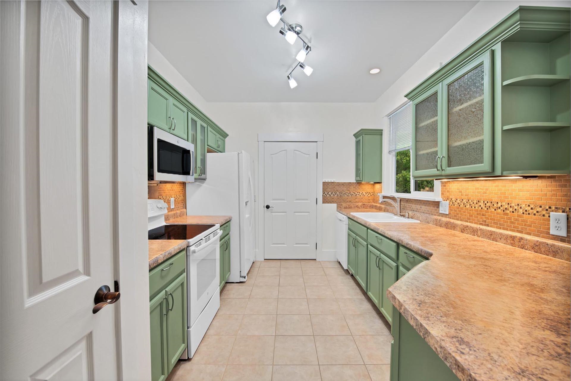 1112 Sunrose Lane, Unit 324 Fruita, CO 81521 - Photo 5 of 21 a kitchen with stainless steel appliances granite countertop a sink and cabinets