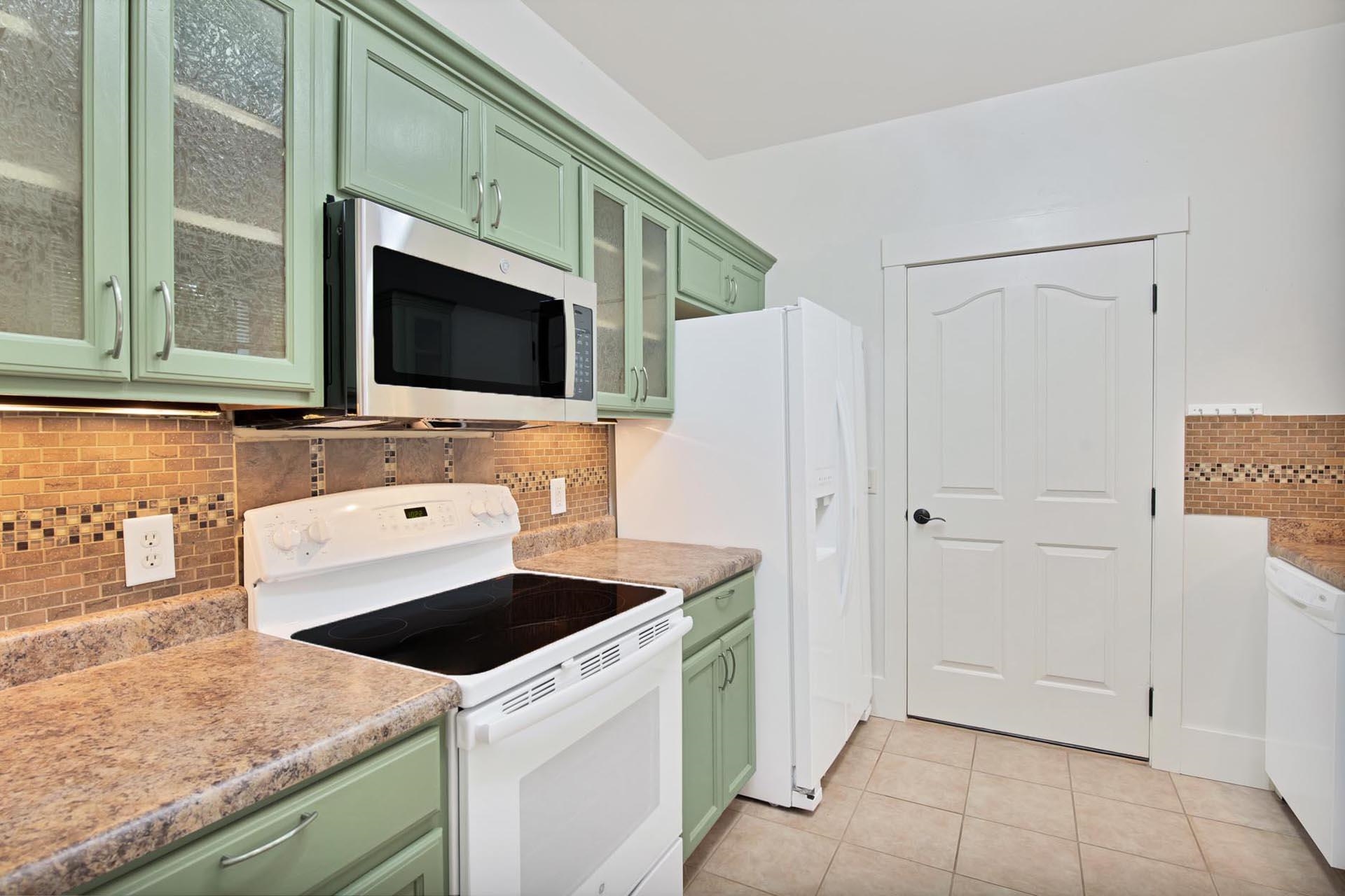 1112 Sunrose Lane, Unit 324 Fruita, CO 81521 - Photo 6 of 21 a kitchen with a sink and a refrigerator