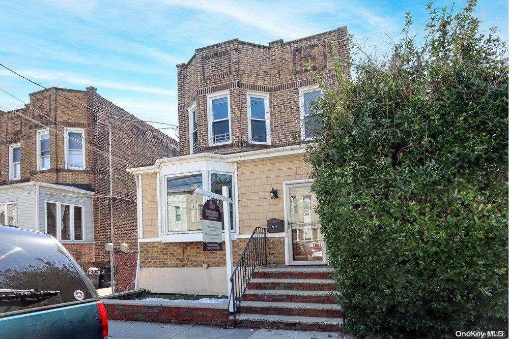 79-12 67th Drive Queens, NY 11379 - Photo 1 of 1 a front view of a house with a yard