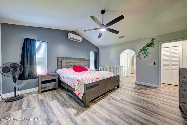 a bedroom with a bed and a chandelier