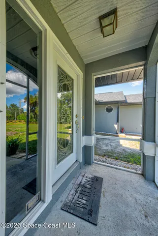 a view of a porch with a table and balcony