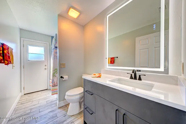 a view of a livingroom with a hall and furniture
